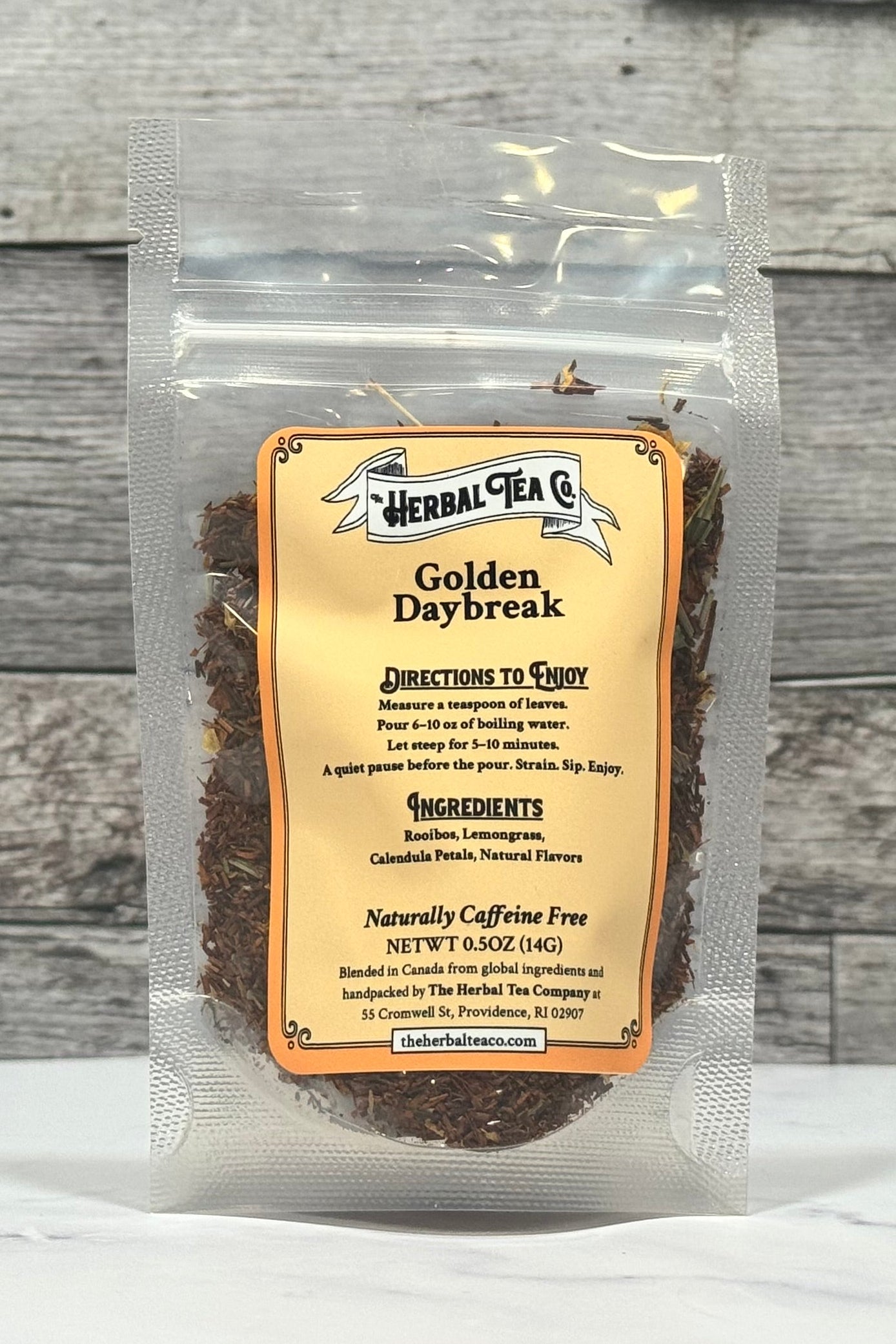 Herbal tea package labeled 'Golden Daybreak' on a wooden surface