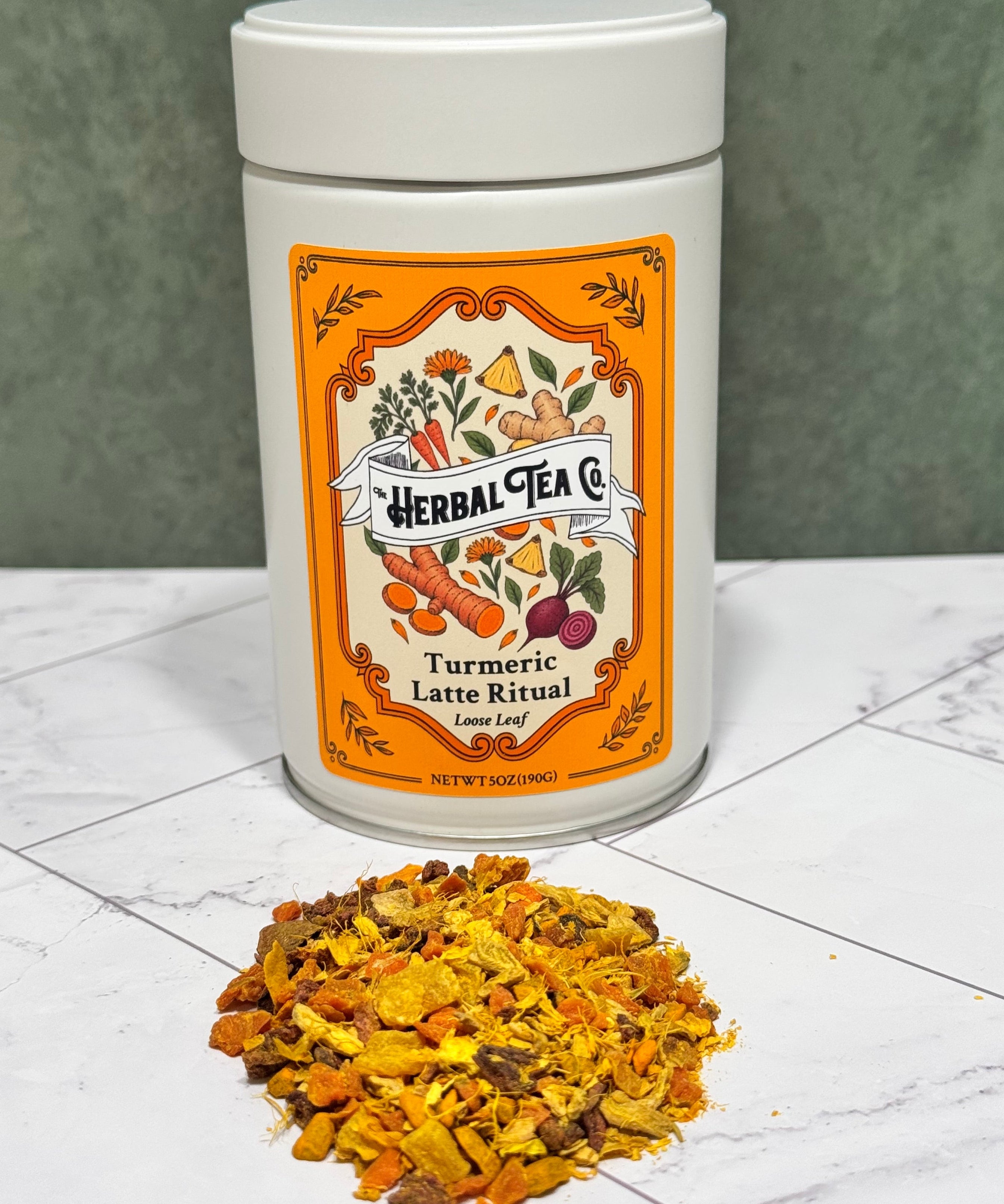 “Turmeric Latte Ritual tea tin with a pile of golden loose-leaf herbal blend on a white tabletop.”
