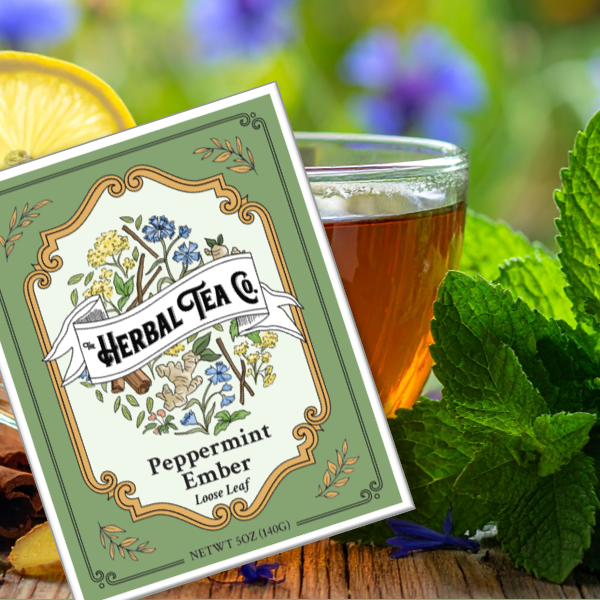 Herbal Tea Co. peppermint ember tea package with a glass of tea and mint leaves on a wooden surface.
