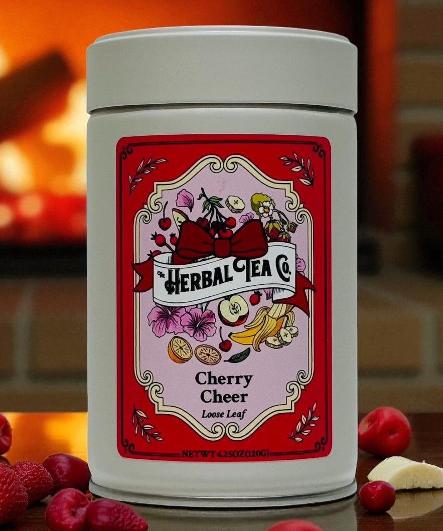 Herbal tea canister with cherry flavor label on a wooden surface in front of a fireplace.