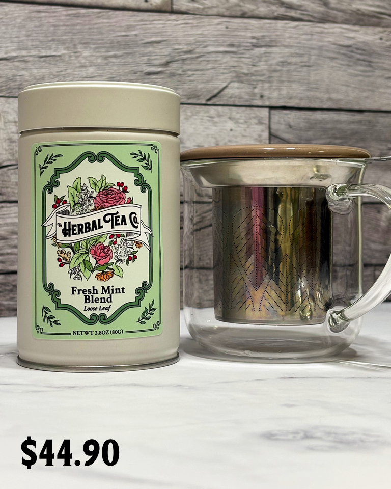 Herbal Tea Co. canister with a glass mug on a wooden surface, priced at $44.95.