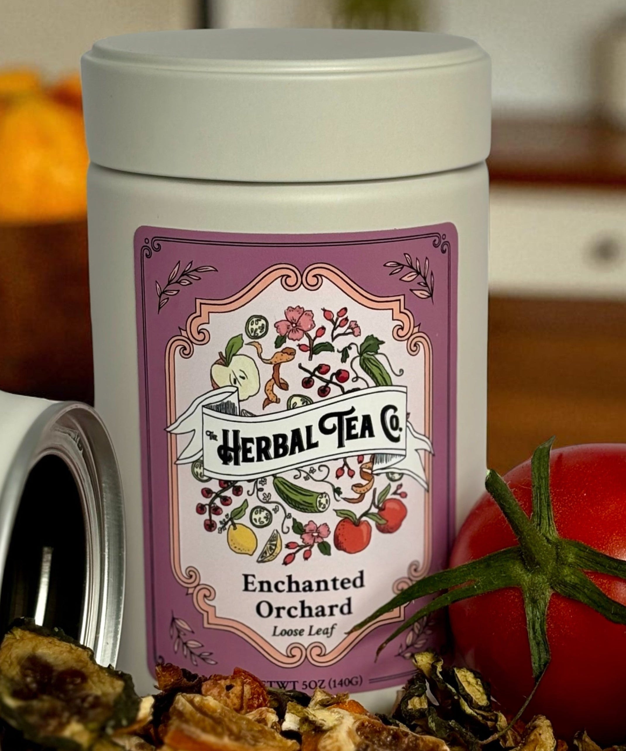Herbal tea canister with a label on a kitchen counter with fruits.