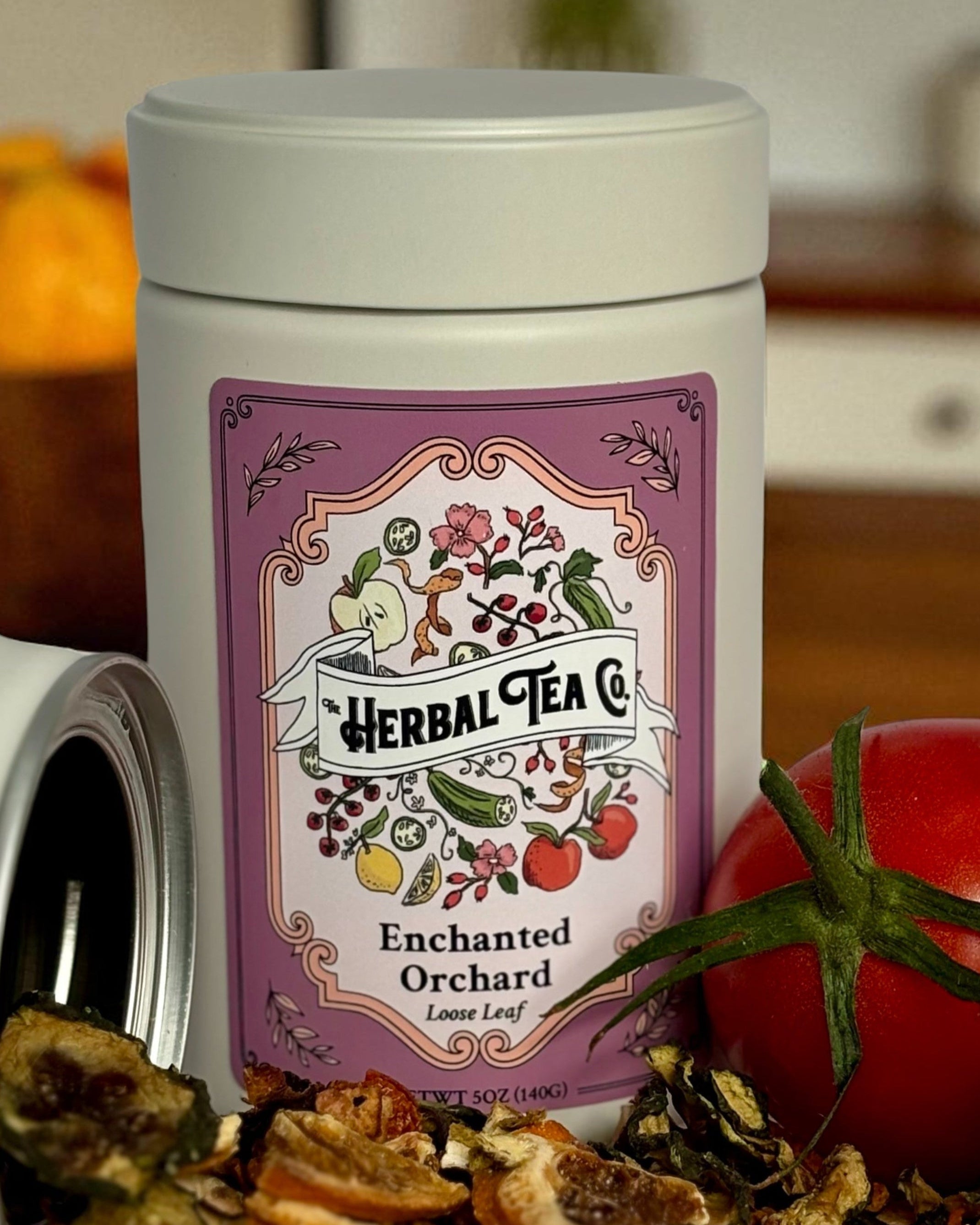 Herbal tea canister with a label on a kitchen counter with fruits.